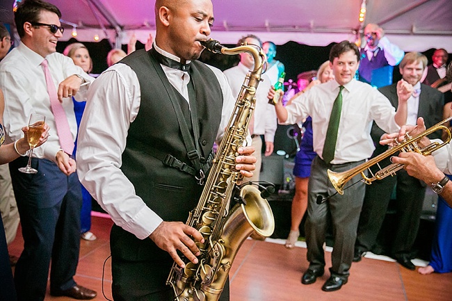 man playing saxophone at wedding reception